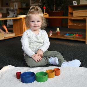 toddler girl with Montessori learning tools, tolieting
