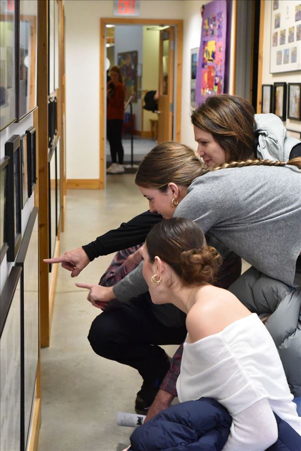 Alumni looking at the wall of history at The Children's House